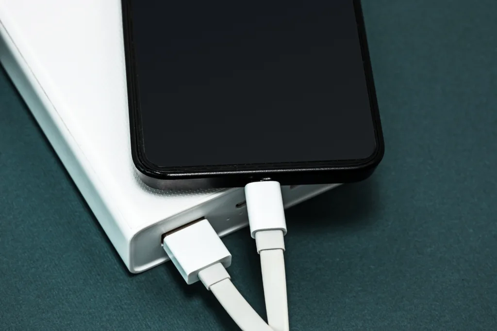 Power bank and mobile phone on gray desk, Apple watch Charging Mechanism